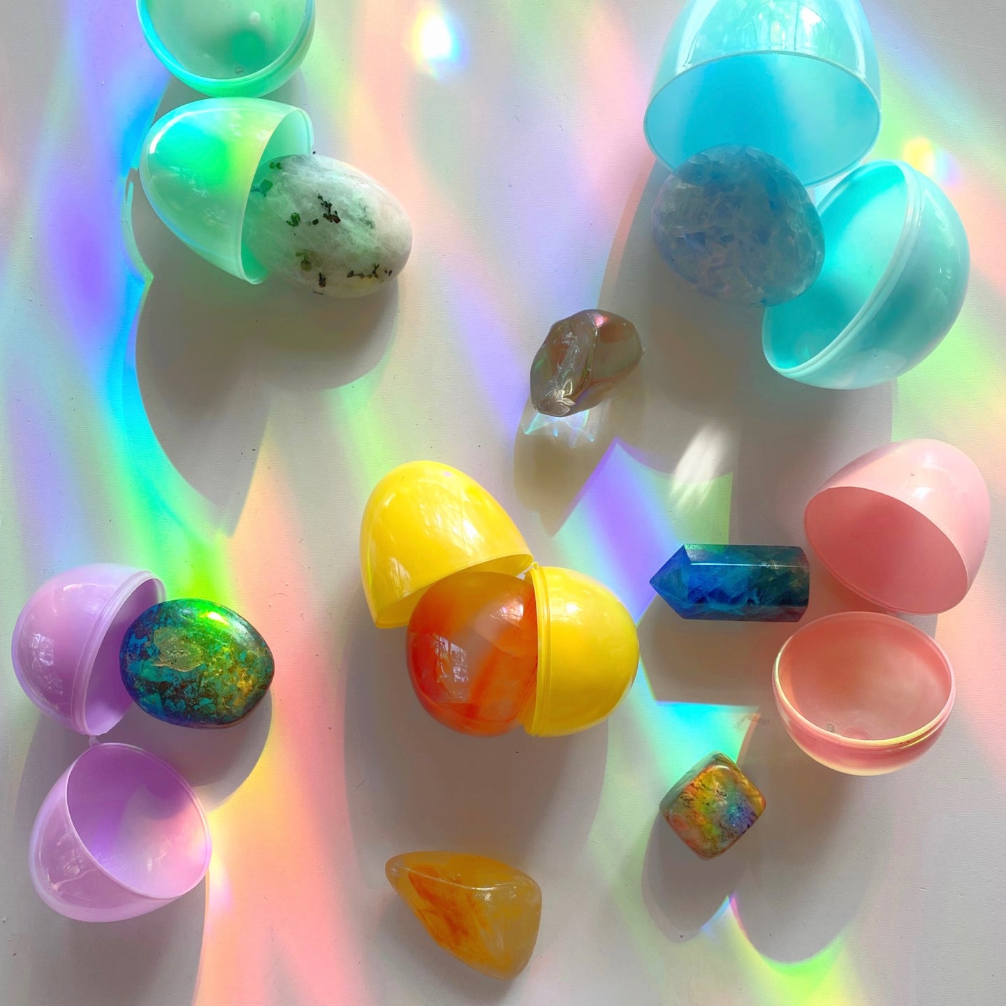 rainbows cascading over a pastel colored Easter opened eggs with crystals inside 